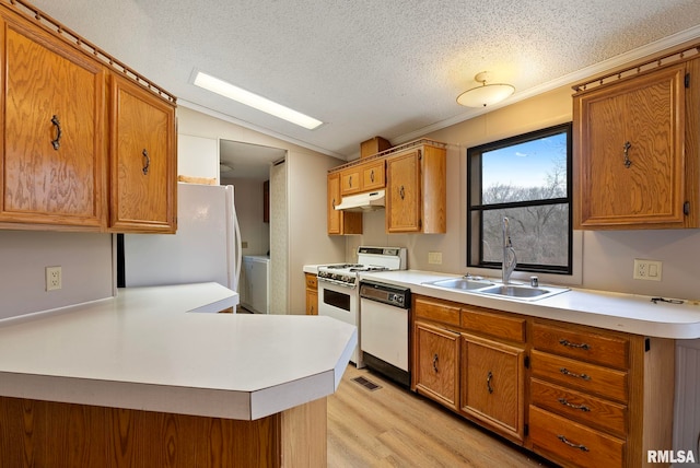 kitchen featuring sink, vaulted ceiling, a textured ceiling, light wood-type flooring, and white appliances