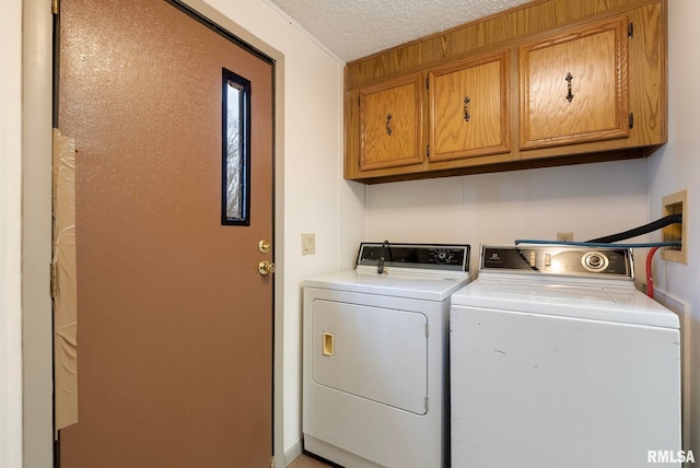 laundry room with cabinets, separate washer and dryer, and a textured ceiling