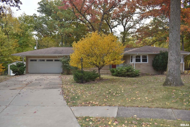 view of front of home featuring a garage and a front lawn