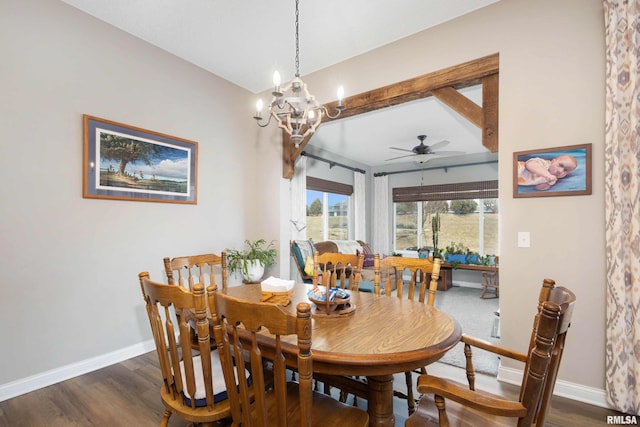 dining room with ceiling fan with notable chandelier and dark hardwood / wood-style flooring