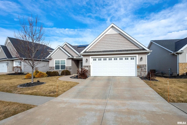 view of front of property featuring a garage, a front lawn, and solar panels