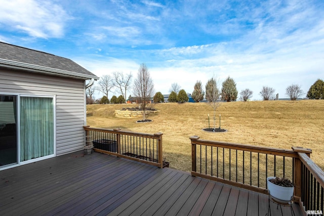 wooden deck featuring a yard