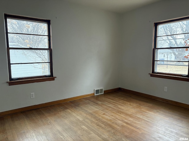 spare room featuring light hardwood / wood-style floors