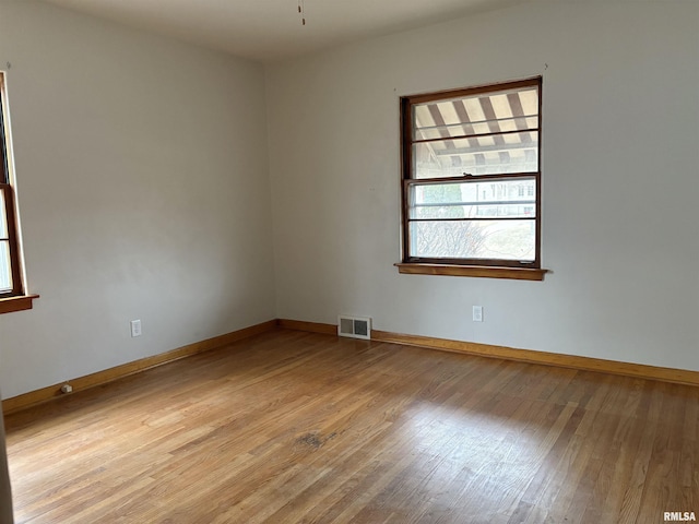 spare room featuring light hardwood / wood-style flooring