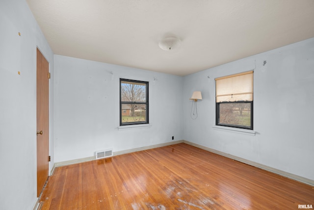 unfurnished room featuring hardwood / wood-style floors