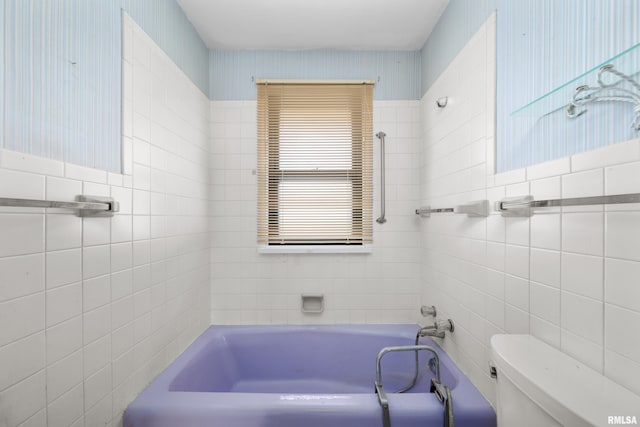 bathroom featuring tile walls, a bath, and toilet