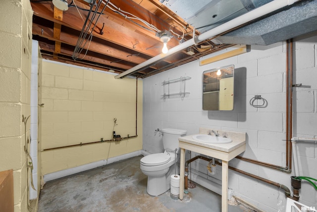 bathroom with sink, concrete floors, and toilet