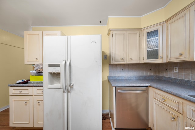 kitchen featuring backsplash, cream cabinets, white fridge with ice dispenser, and dishwasher