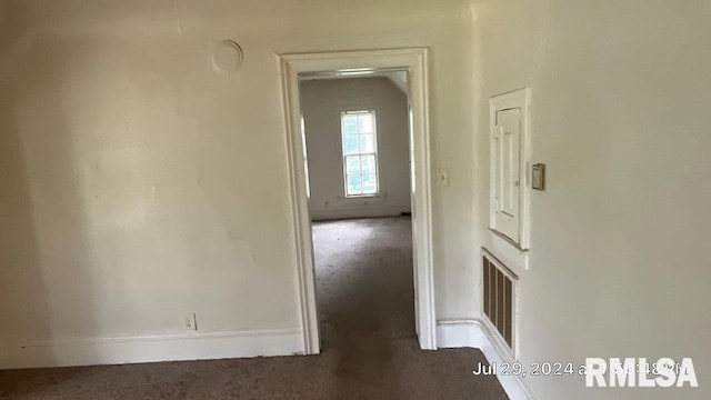 hallway featuring dark carpet