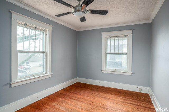 unfurnished living room with ornamental molding, a brick fireplace, a textured ceiling, and light hardwood / wood-style flooring