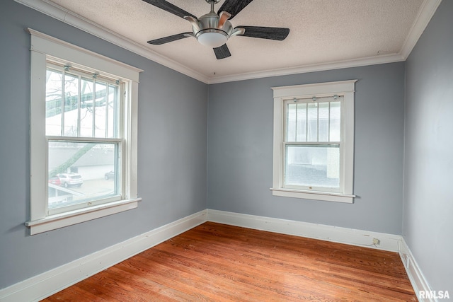 spare room with crown molding, ceiling fan, light hardwood / wood-style flooring, and a textured ceiling