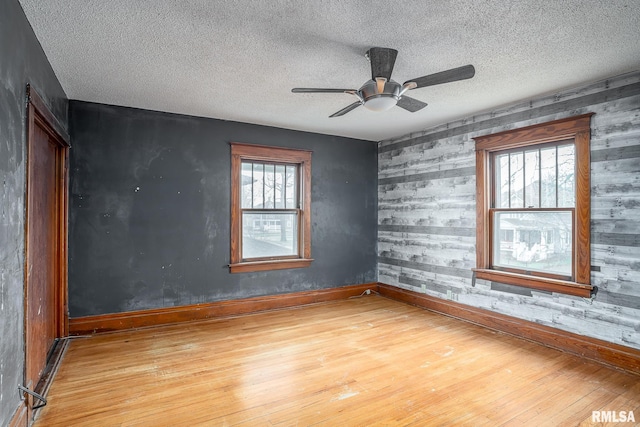 spare room featuring hardwood / wood-style floors, a textured ceiling, and ceiling fan