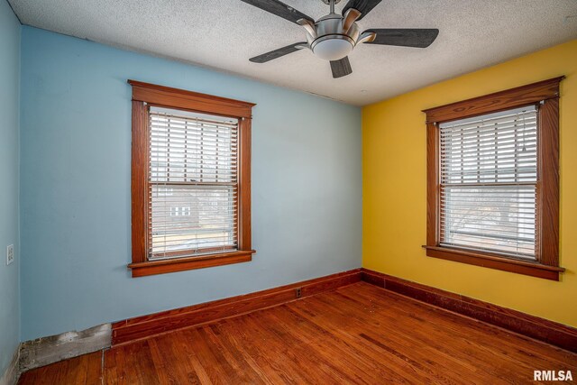 spare room featuring ceiling fan, ornamental molding, light hardwood / wood-style floors, and a textured ceiling