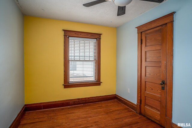 unfurnished bedroom with hardwood / wood-style flooring, ornamental molding, a closet, and a textured ceiling