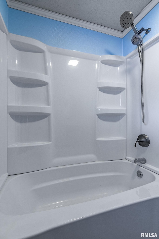 bathroom featuring washtub / shower combination and a textured ceiling