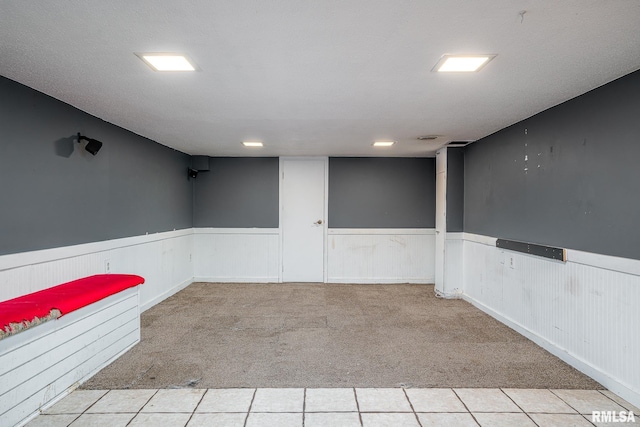 basement featuring light colored carpet