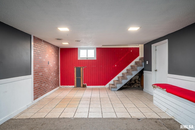 basement featuring carpet flooring and a textured ceiling