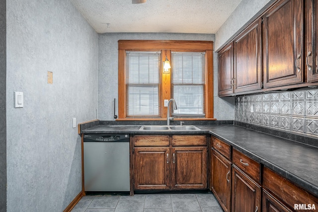 kitchen with sink, dishwasher, dark brown cabinets, a textured ceiling, and light tile patterned flooring