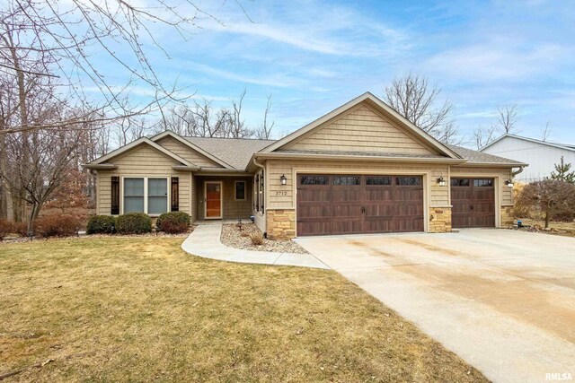 view of front of home featuring a garage and a front lawn