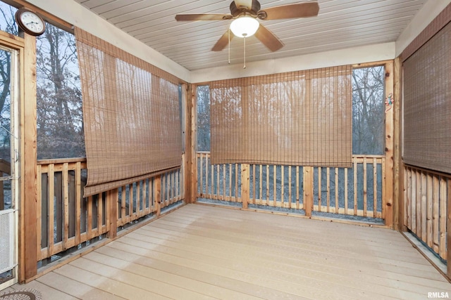 unfurnished sunroom featuring ceiling fan