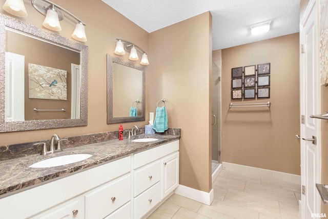 bathroom featuring walk in shower, tile patterned floors, vanity, and a textured ceiling