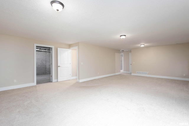 carpeted spare room with a textured ceiling