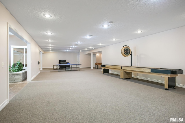 interior space with light carpet and a textured ceiling