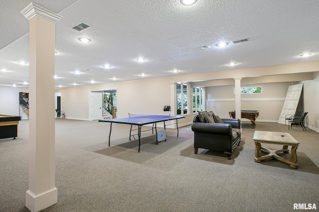 game room with ornate columns, light carpet, and a textured ceiling