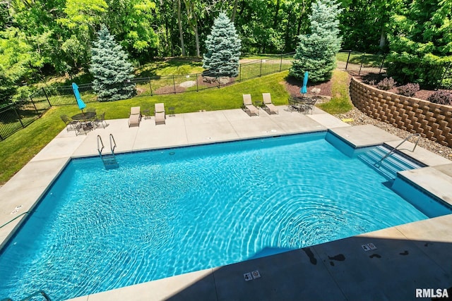 view of swimming pool featuring a yard and a patio