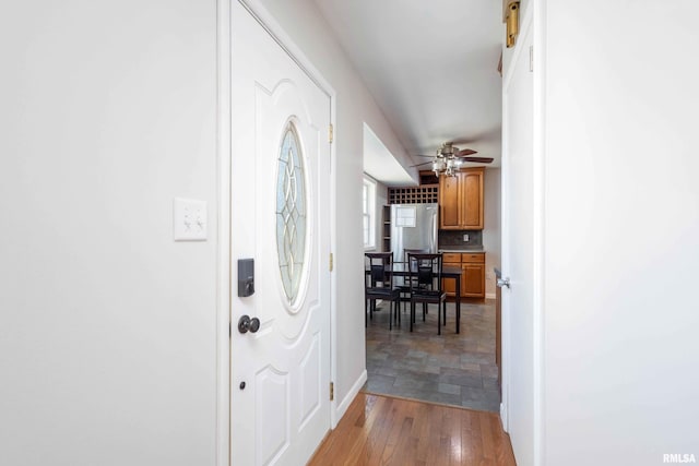 foyer entrance featuring ceiling fan and light hardwood / wood-style flooring