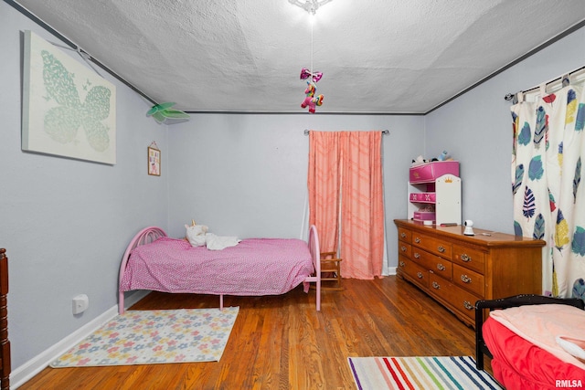 bedroom featuring hardwood / wood-style floors and a textured ceiling