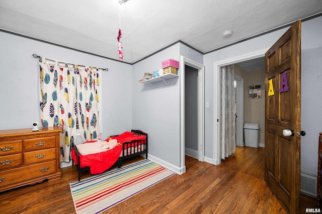 bedroom with crown molding and dark hardwood / wood-style flooring