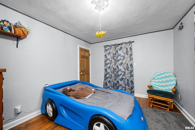 bedroom featuring dark hardwood / wood-style floors and a textured ceiling