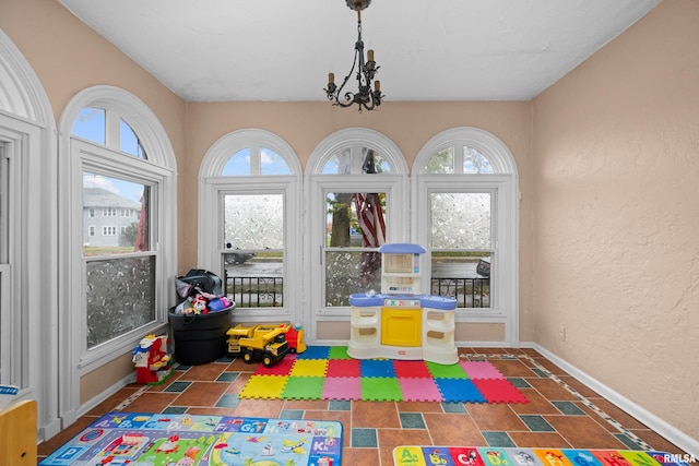 rec room with a notable chandelier