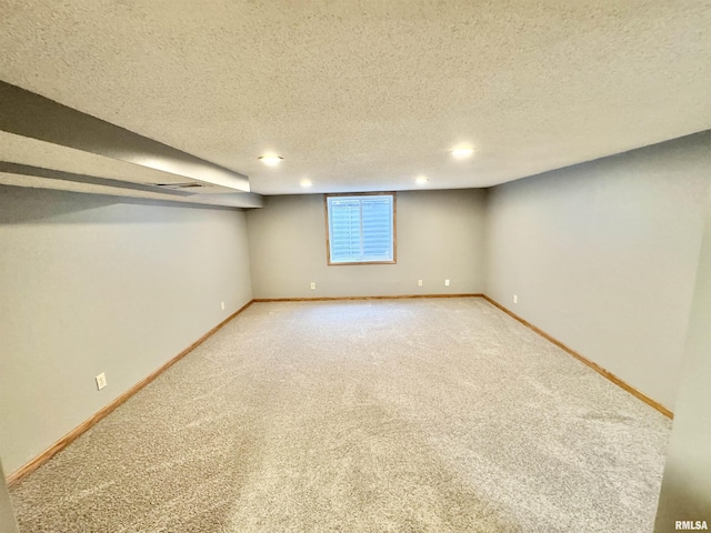 basement with carpet and a textured ceiling