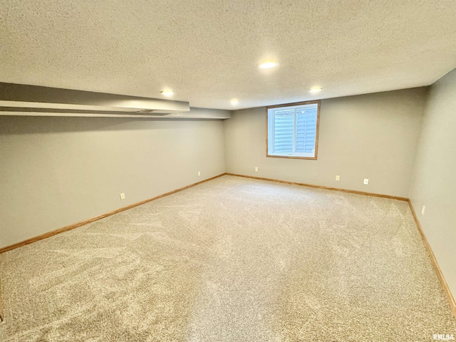 basement with a textured ceiling and carpet flooring