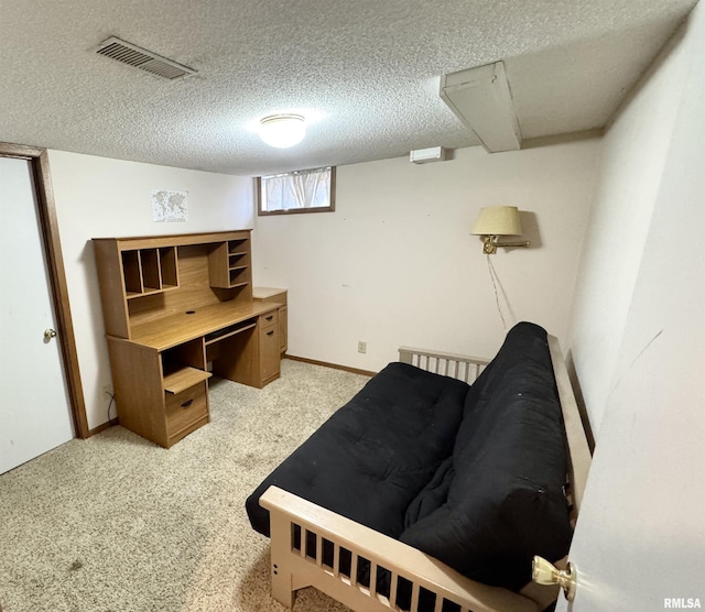 bedroom featuring light carpet and a textured ceiling