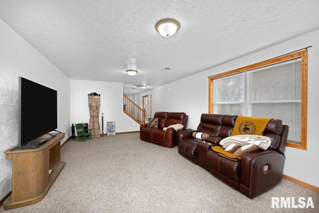 living room featuring light colored carpet and a textured ceiling