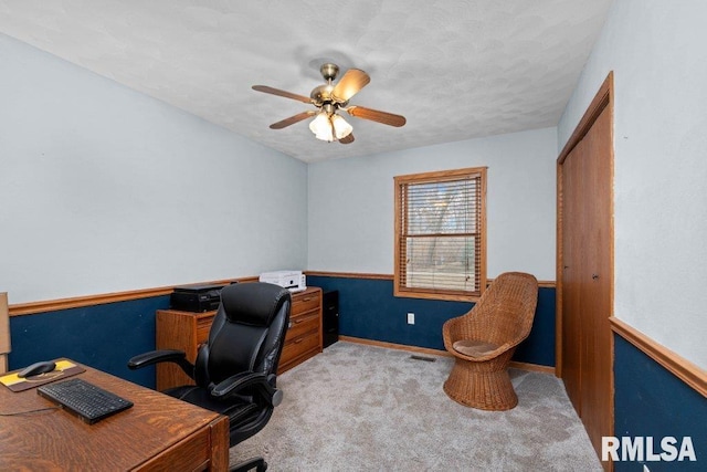 carpeted office featuring ceiling fan