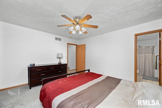 carpeted bedroom featuring ceiling fan and ensuite bathroom