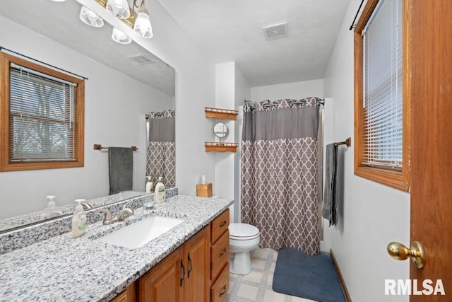 bathroom featuring vanity, toilet, and a shower with shower curtain