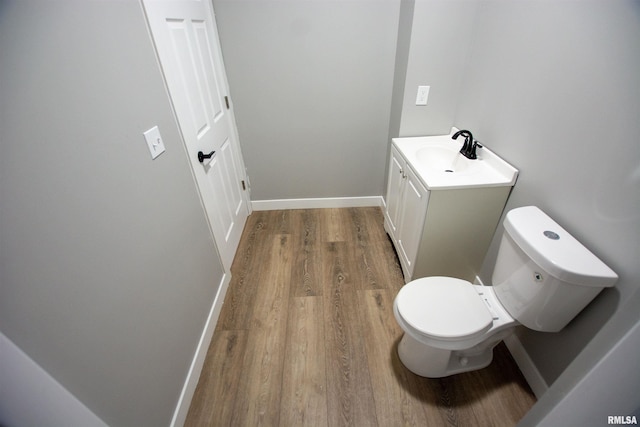 bathroom featuring vanity, toilet, and wood-type flooring