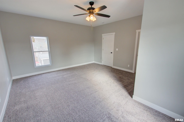 carpeted spare room with ceiling fan