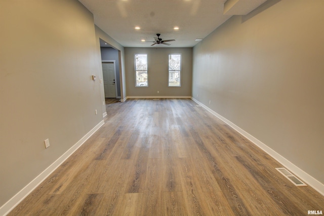 spare room featuring hardwood / wood-style flooring and ceiling fan