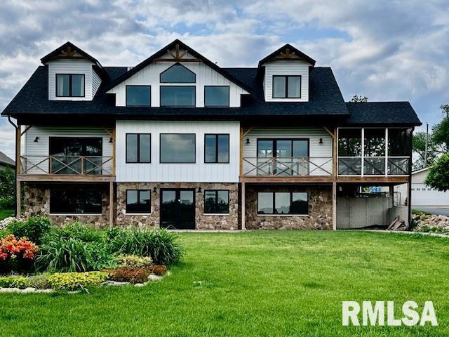 1403 SW Canal Shore Dr, Le Claire, IA 52753 - back of property featuring stone siding, a yard, a balcony, and a sunroom