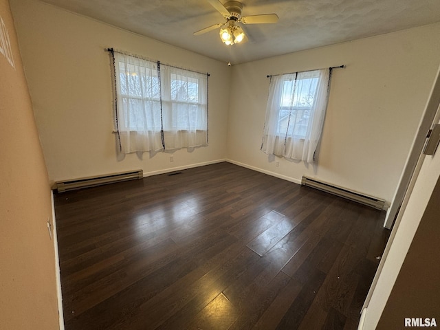 empty room with ceiling fan, a baseboard radiator, and dark hardwood / wood-style flooring