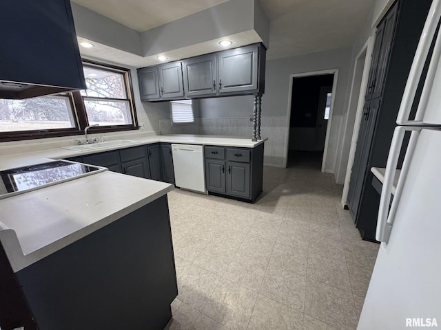 kitchen with white appliances, gray cabinets, and sink