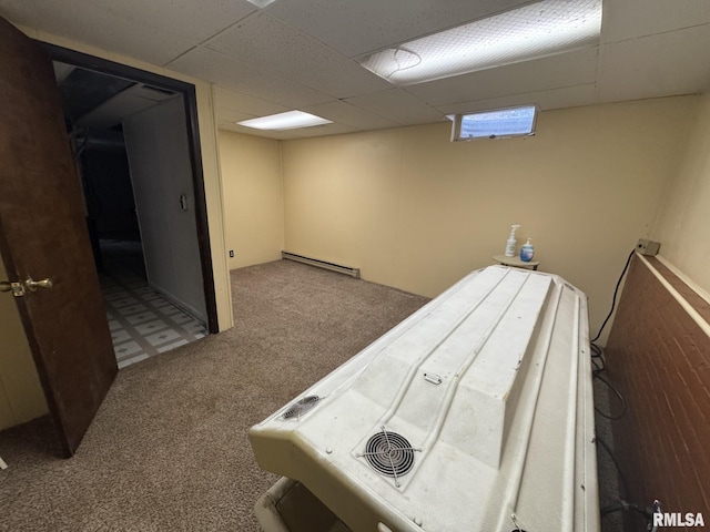 interior space featuring a baseboard radiator, carpet, and a drop ceiling