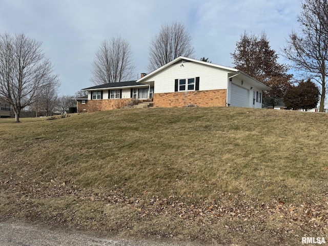 view of front of home with a garage and a front lawn