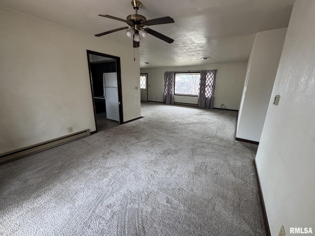 spare room featuring ceiling fan, a baseboard radiator, and carpet flooring